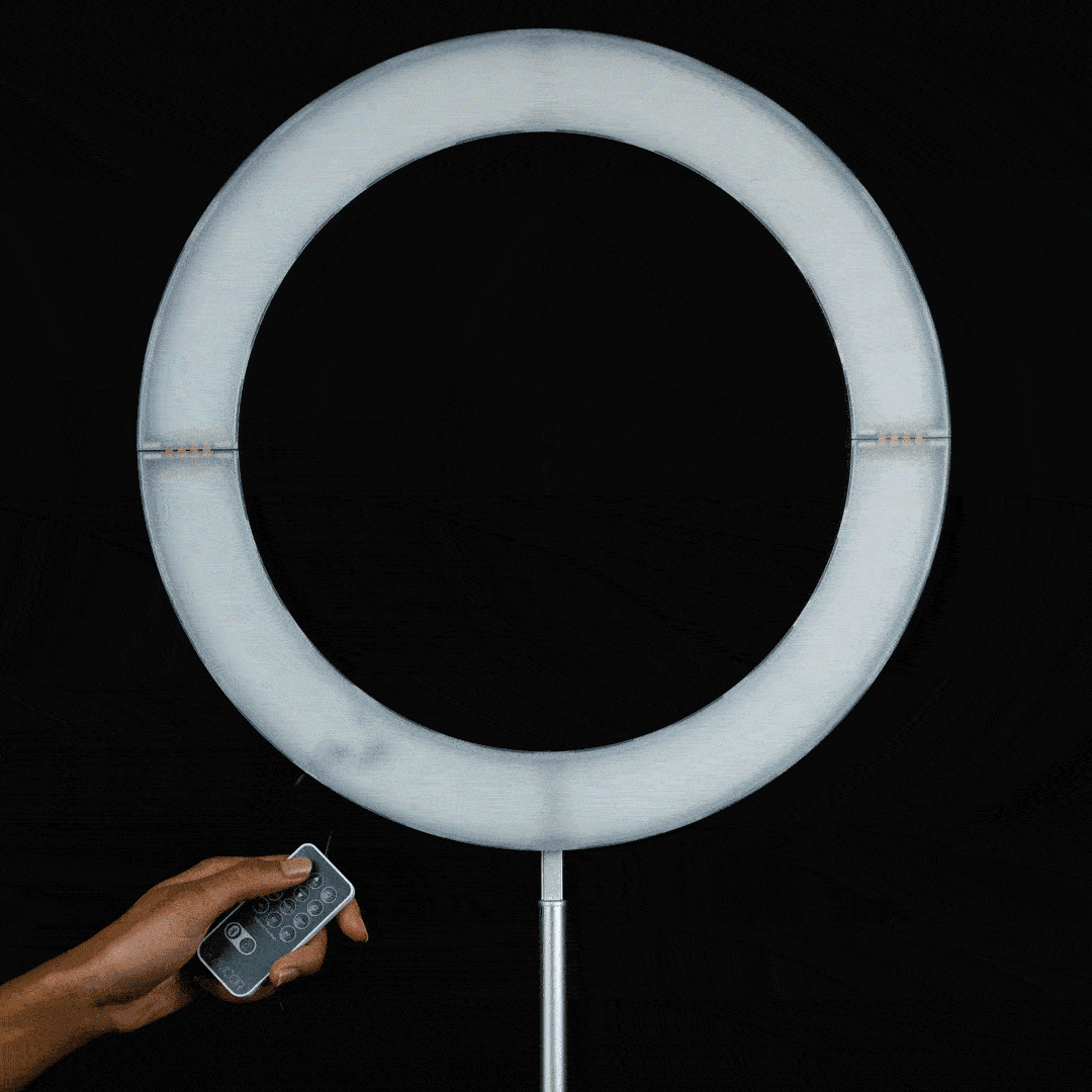 A hand on the GALILEO remote in front of the lit ring